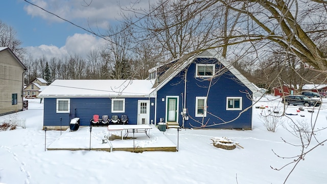 view of snow covered rear of property