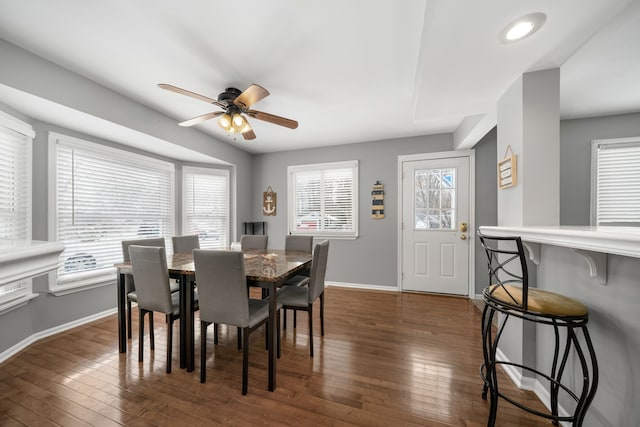 dining space with dark hardwood / wood-style floors and ceiling fan