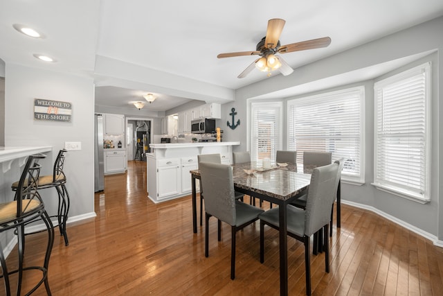 dining space featuring hardwood / wood-style floors and ceiling fan