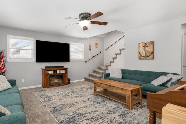 living room featuring ceiling fan, a healthy amount of sunlight, and carpet flooring