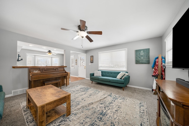 living room with ceiling fan and carpet floors