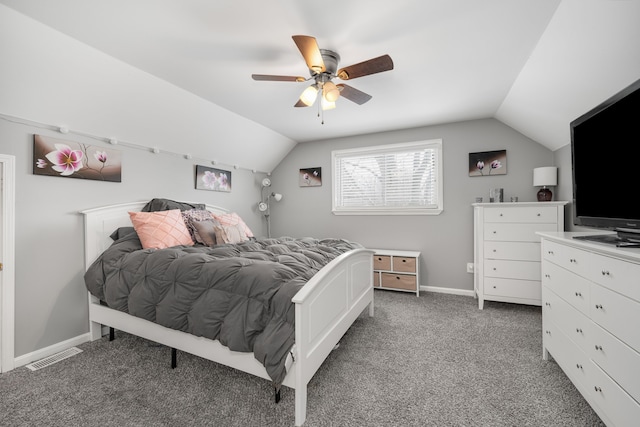 bedroom featuring dark colored carpet, vaulted ceiling, and ceiling fan