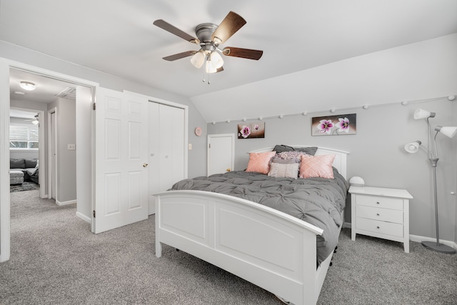 bedroom with vaulted ceiling, light carpet, ceiling fan, and a closet