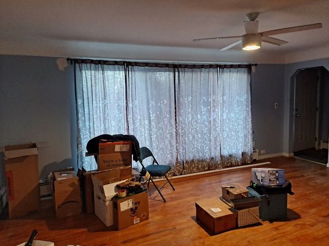 living area with hardwood / wood-style flooring and ceiling fan