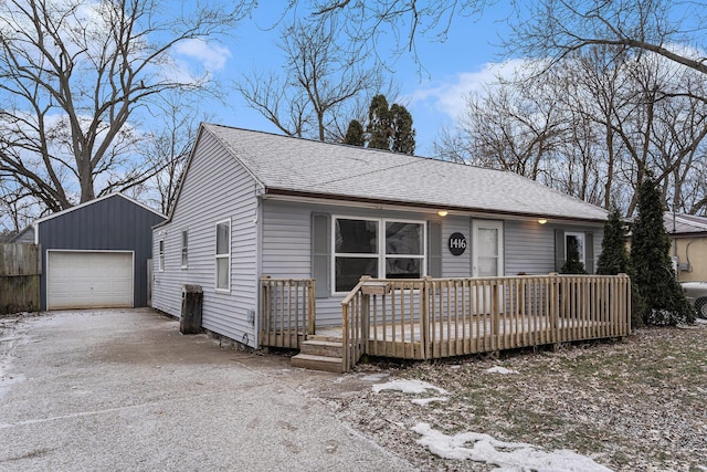 view of front of home with a garage, an outdoor structure, and a deck