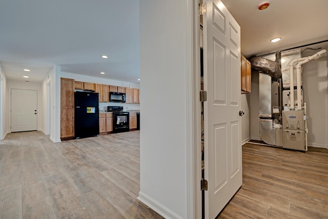 hallway with light hardwood / wood-style floors