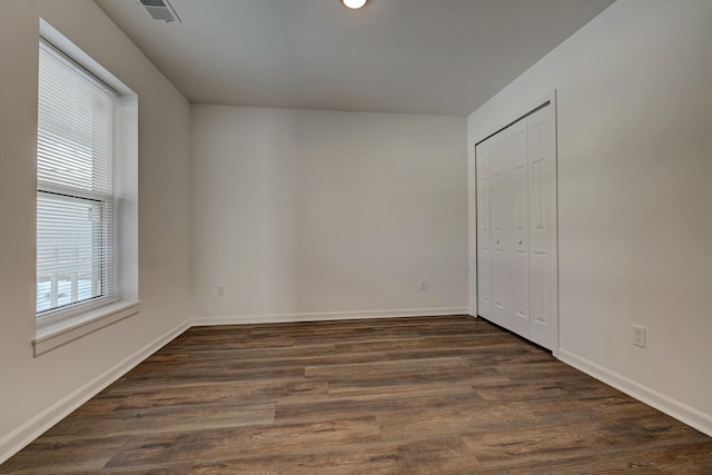 spare room featuring dark hardwood / wood-style flooring