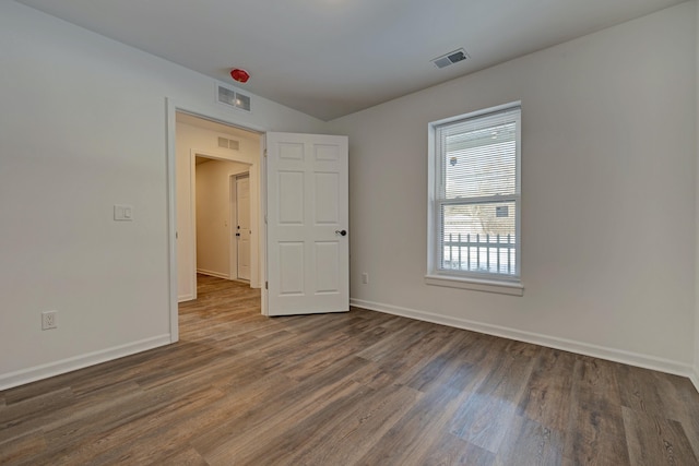 unfurnished room with dark hardwood / wood-style floors