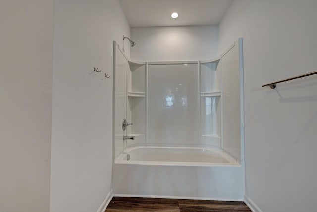 bathroom with wood-type flooring and tub / shower combination