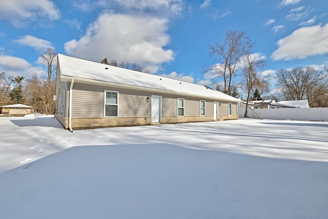 view of snow covered back of property