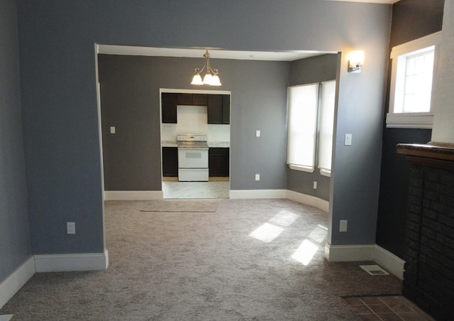 living room with light colored carpet, a healthy amount of sunlight, and a chandelier