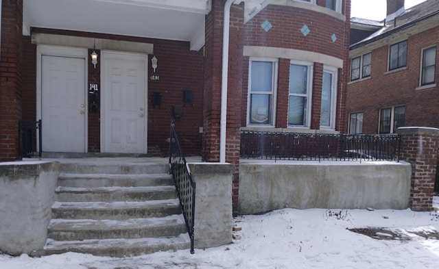 view of snow covered property entrance