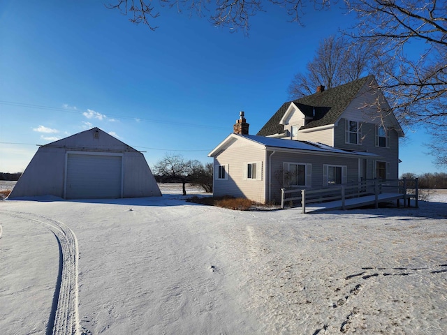 view of home's exterior featuring a garage and an outbuilding