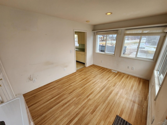 spare room with light wood-type flooring