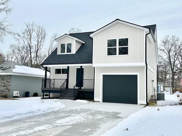 view of front of home with a garage and central air condition unit