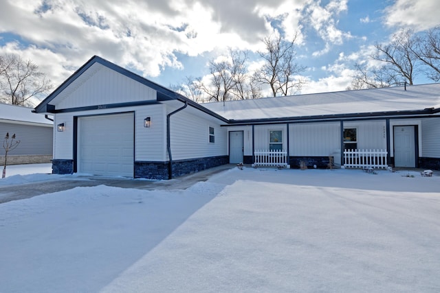 single story home featuring a garage and covered porch