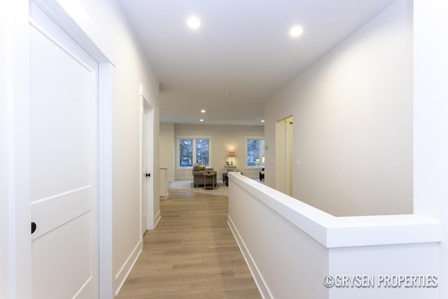 corridor with light hardwood / wood-style floors