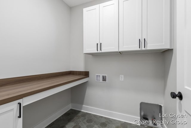 washroom featuring cabinet space, baseboards, and hookup for a washing machine