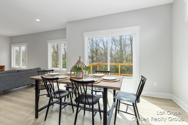 dining space with light wood-style floors, baseboards, and recessed lighting