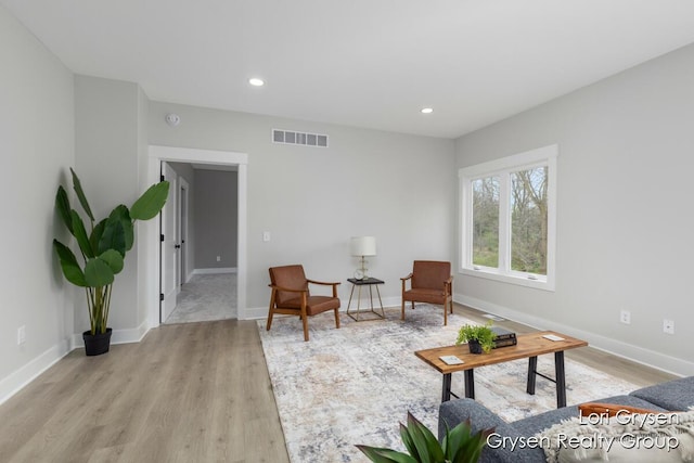 sitting room with visible vents, recessed lighting, light wood finished floors, and baseboards