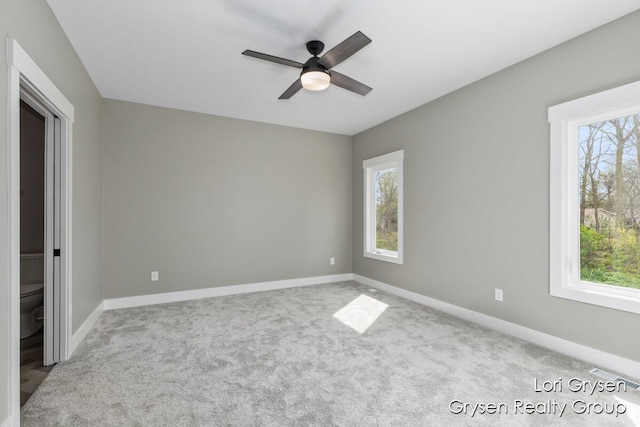unfurnished bedroom with carpet floors, baseboards, ceiling fan, and visible vents