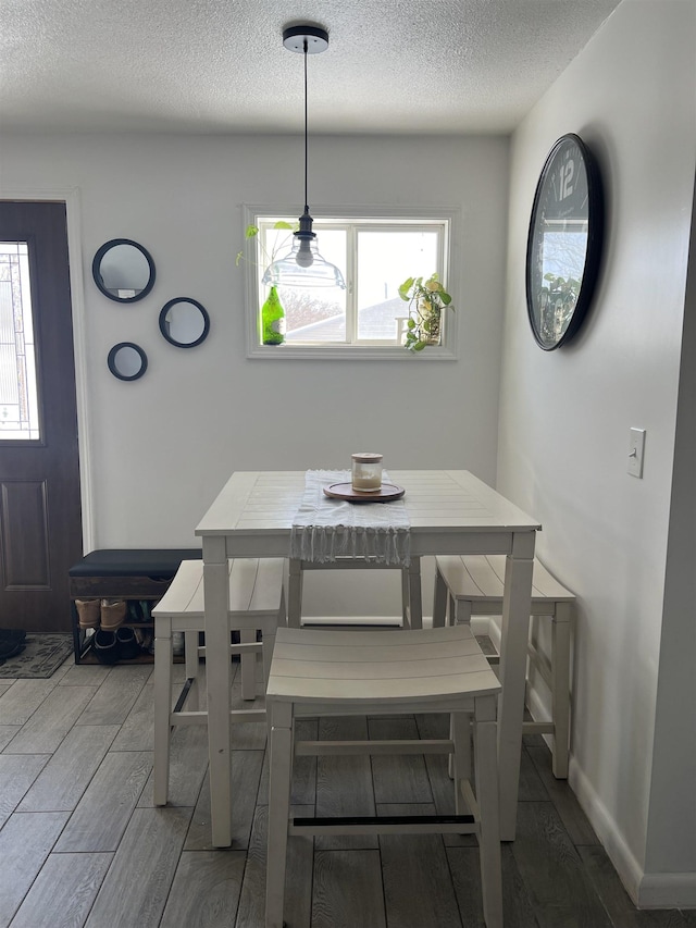 dining area with plenty of natural light and a textured ceiling