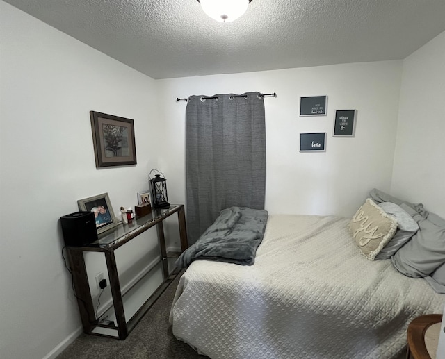 carpeted bedroom with a textured ceiling