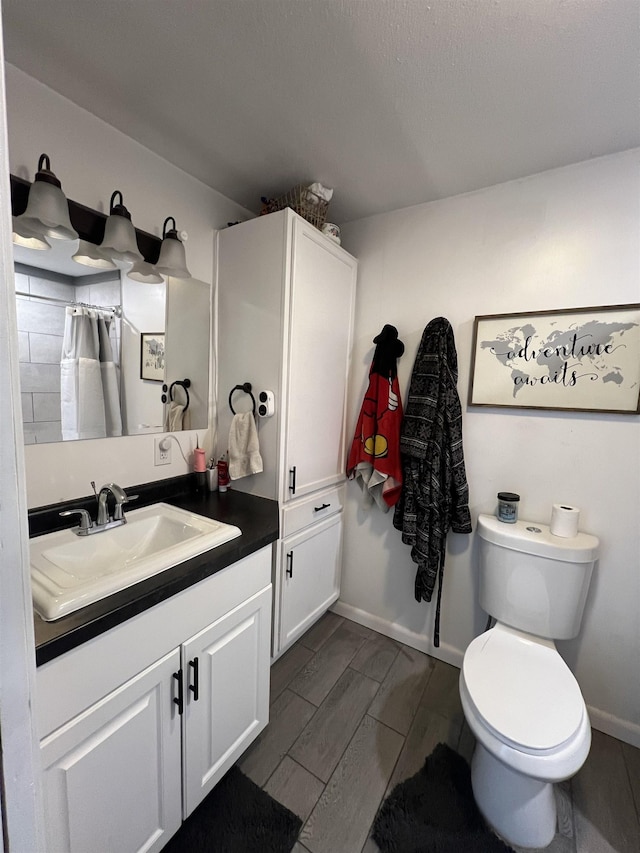 8017 S Saginaw St, New Lothrop, MI 48460 - bathroom with toilet, vanity, curtained shower, and baseboards