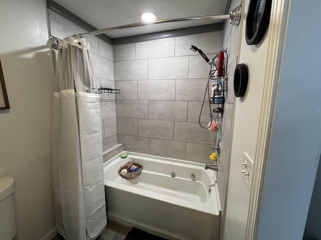 bathroom featuring shower / bath combination with curtain and toilet