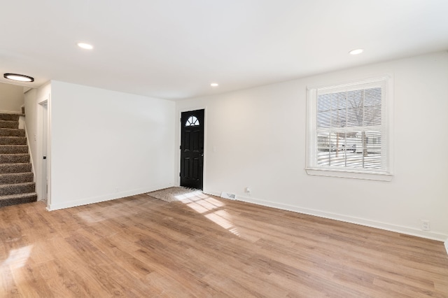 unfurnished room with light wood-type flooring