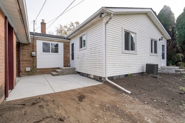 rear view of house featuring cooling unit and a patio