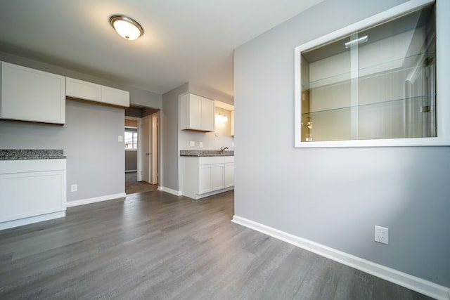 kitchen featuring white cabinetry and dark hardwood / wood-style flooring