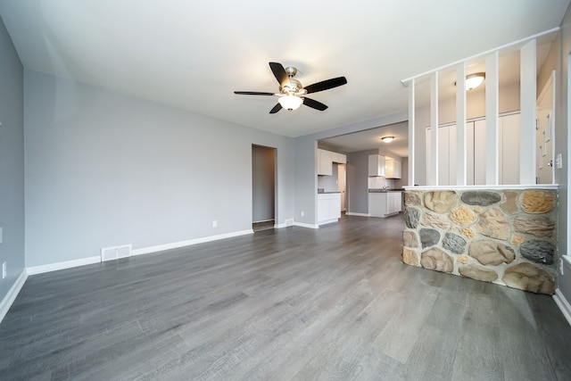 unfurnished living room featuring ceiling fan and hardwood / wood-style floors