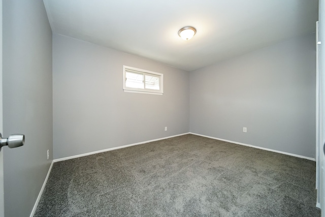 empty room with dark colored carpet