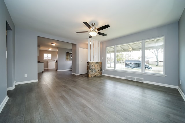 unfurnished living room featuring dark hardwood / wood-style flooring and ceiling fan