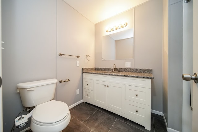 bathroom featuring tile patterned floors, vanity, and toilet