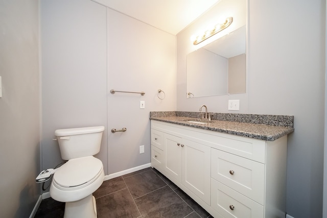 bathroom with vanity, tile patterned floors, and toilet