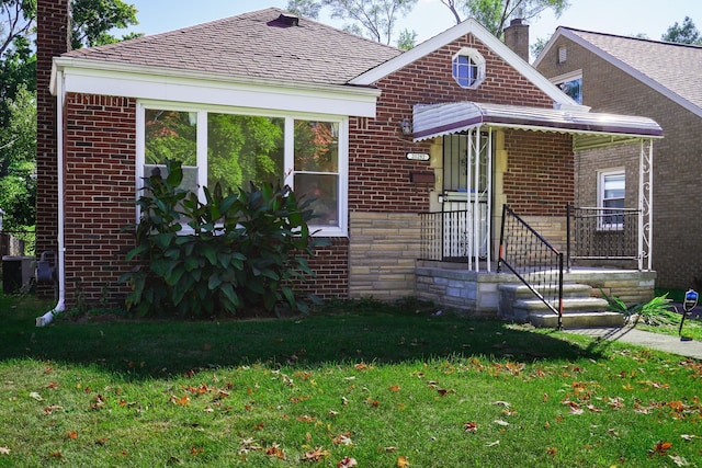 bungalow-style house with a front lawn