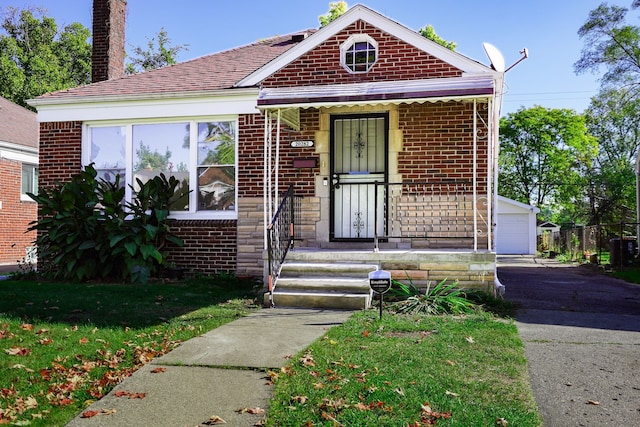 bungalow-style home featuring a garage and a front lawn