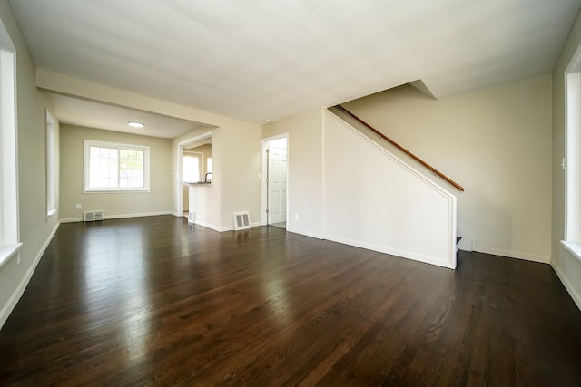 unfurnished living room with dark hardwood / wood-style floors