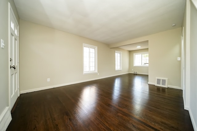 spare room with dark hardwood / wood-style floors