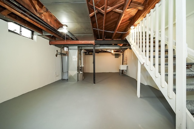 basement with sink, heating unit, and gas water heater