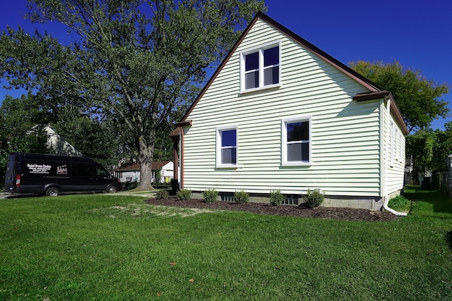 view of side of home with a lawn