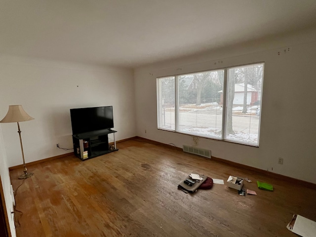 unfurnished living room with wood-type flooring