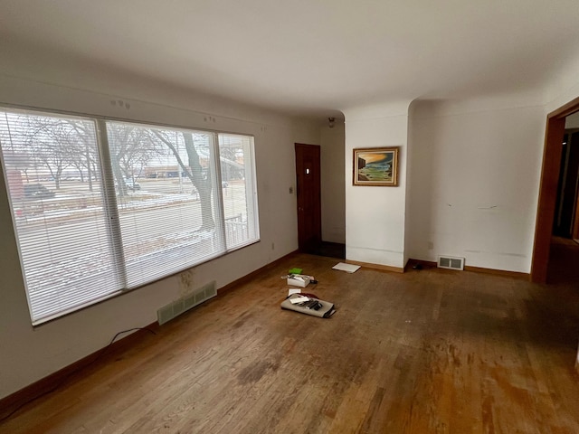 unfurnished living room featuring hardwood / wood-style floors