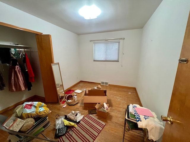 bedroom with a closet and hardwood / wood-style floors