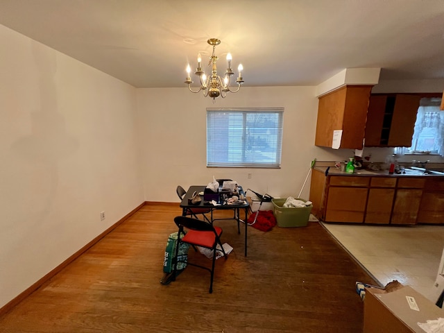 dining room with light wood-type flooring and an inviting chandelier