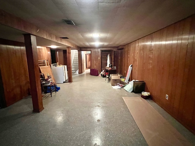 basement with washer / dryer and wooden walls