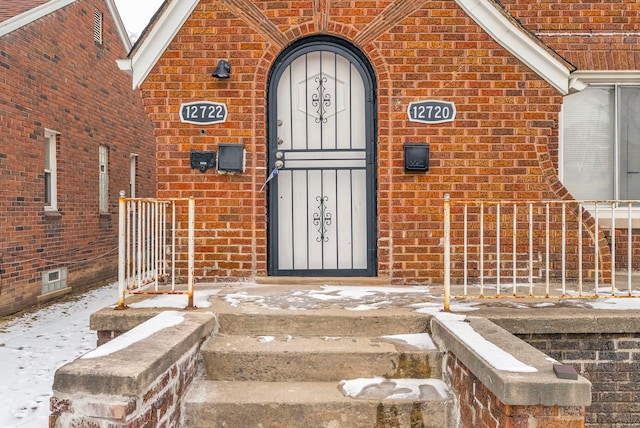 view of snow covered property entrance