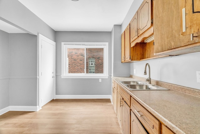 kitchen featuring sink and light wood-type flooring